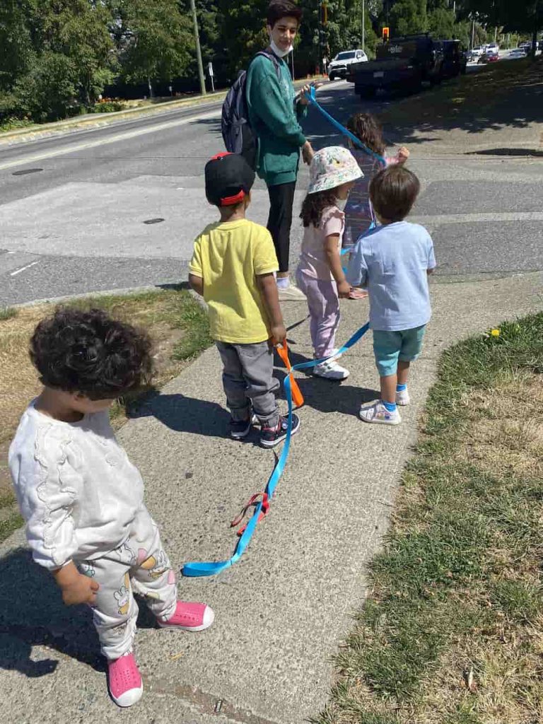 Children on a supervised outdoor walk with their teacher at Rose Child Care Center in North Vancouver