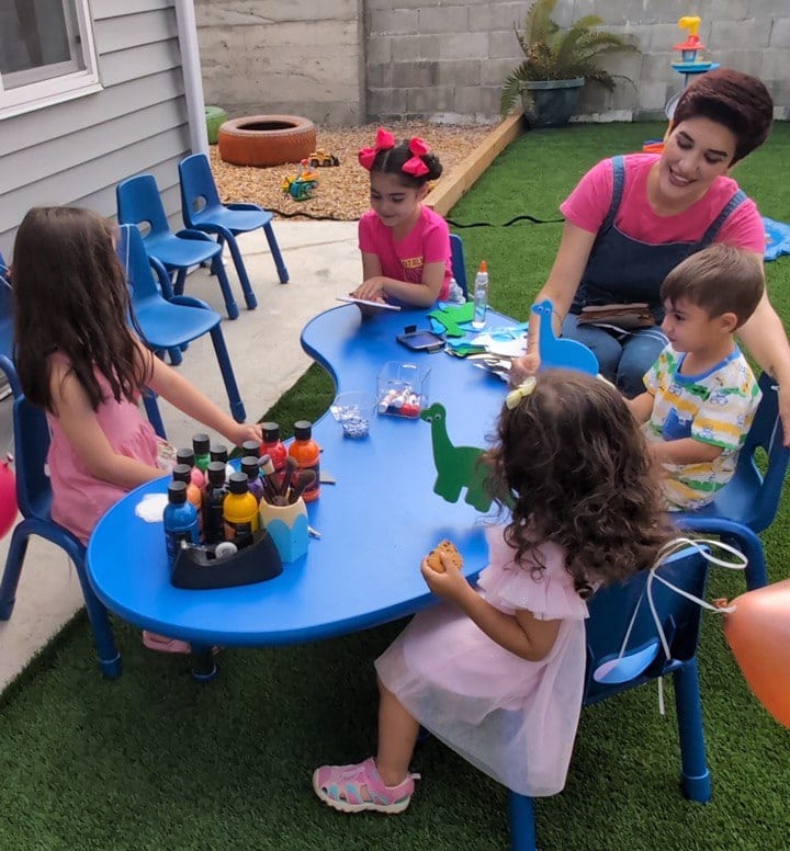 Child psychologist guiding children in an outdoor Montessori play session at Rose Child Care Center in North Vancouver